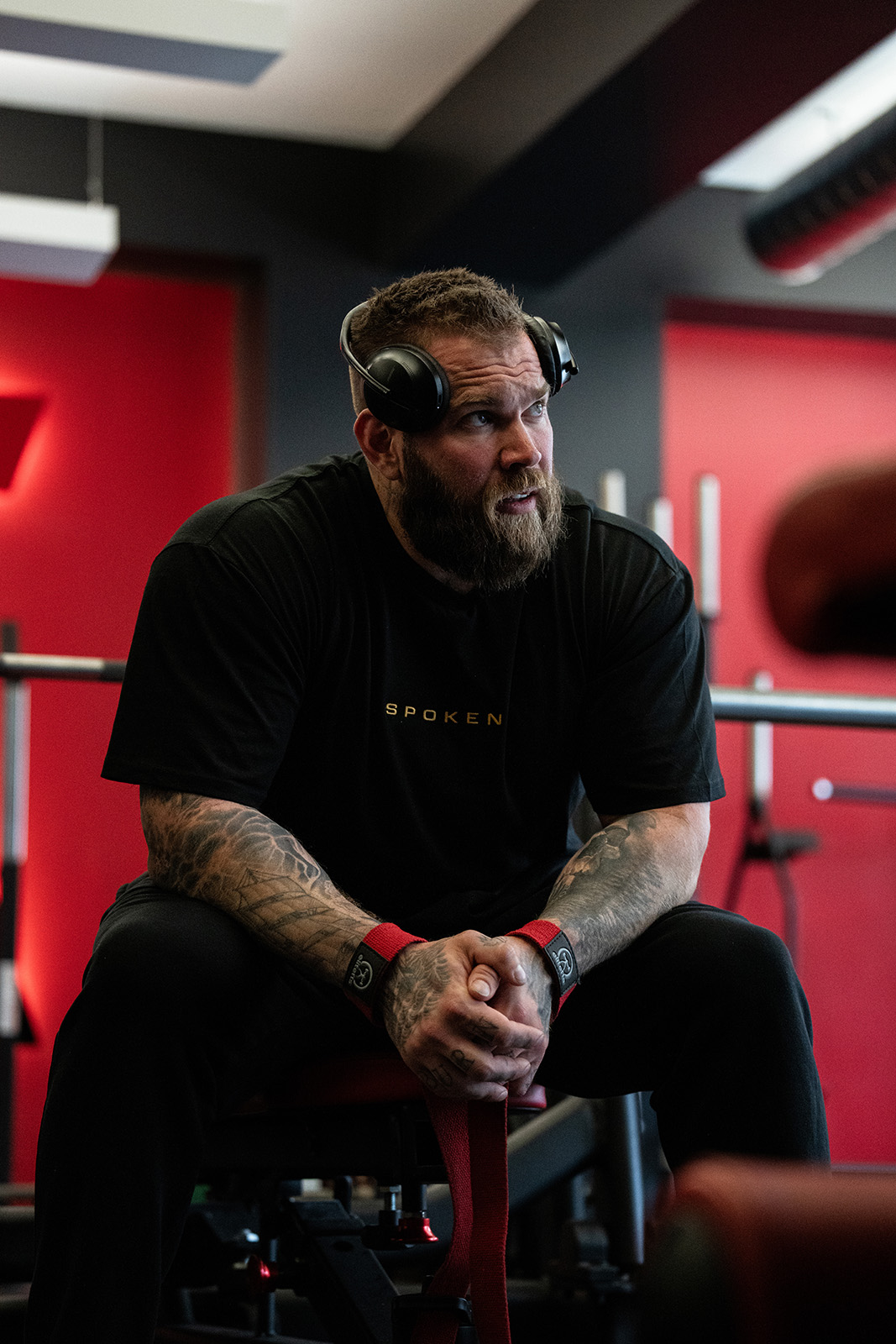A Spoken athlete seated in a training room